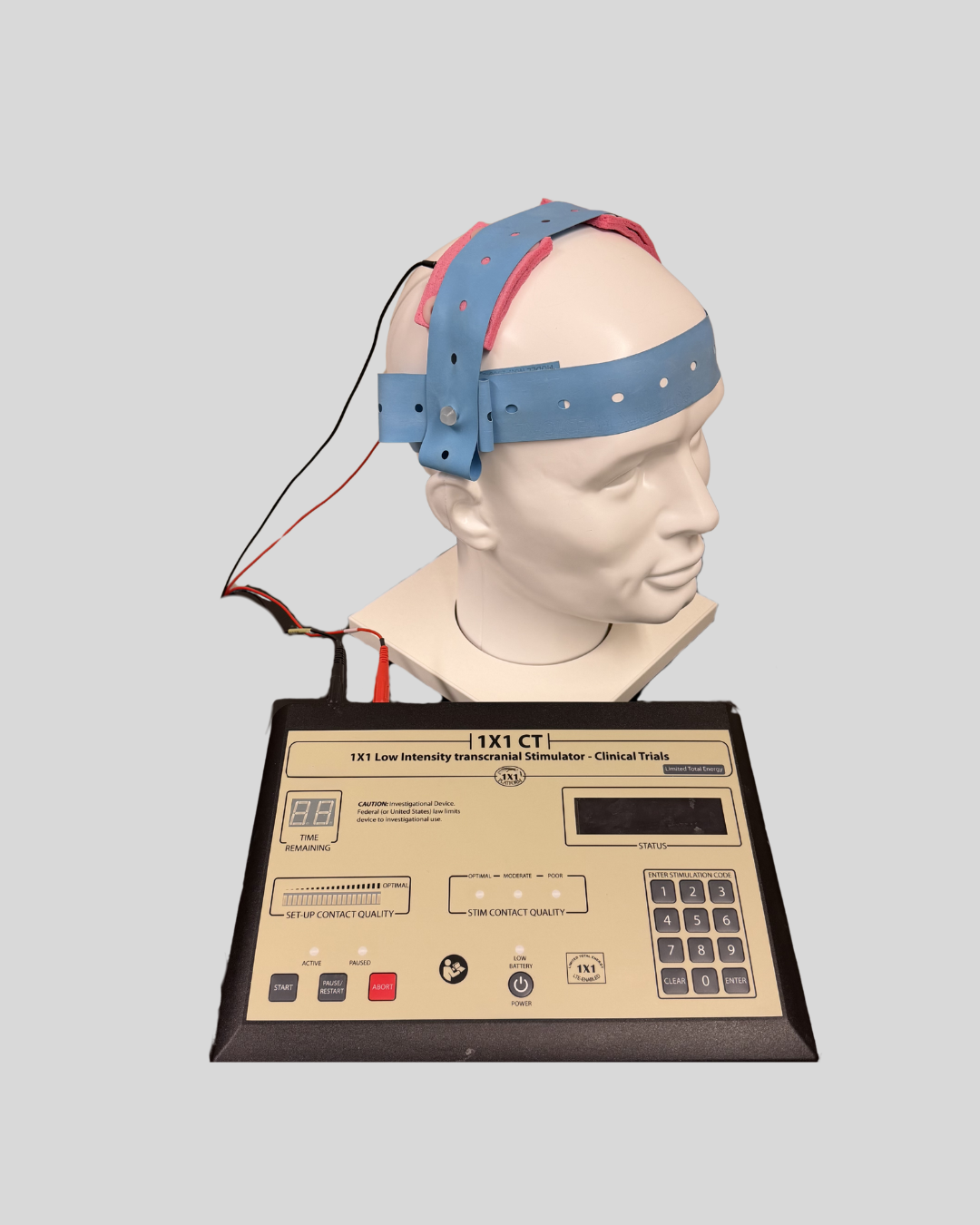 Image of a Transcranial Direct Current Stimulation Device connected to a model of a human head.